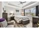 Relaxing main bedroom featuring a tray ceiling, luxury vinyl flooring, stylish furniture, and a beautiful window view at 222 Toscavilla Blvd, Nokomis, FL 34275