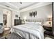 Beautiful main bedroom showcasing contemporary decor, luxury vinyl flooring, and a view of the en suite bathroom at 222 Toscavilla Blvd, Nokomis, FL 34275