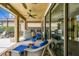 Relaxing covered patio featuring a summer kitchen, comfortable seating, and seamless indoor-outdoor living at 222 Toscavilla Blvd, Nokomis, FL 34275
