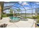 Beautiful pool and spa with screened enclosure, offering serene lake views and lush landscaping at 222 Toscavilla Blvd, Nokomis, FL 34275