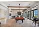 Spacious recreation room with pool table, bar, and expansive windows at 222 Toscavilla Blvd, Nokomis, FL 34275