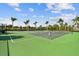 Community tennis and pickleball courts with lush green surroundings and well-maintained nets for outdoor enjoyment at 222 Toscavilla Blvd, Nokomis, FL 34275