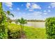 Scenic water view featuring lush landscaping, a serene lake, and blue skies, creating a peaceful outdoor oasis at 222 Toscavilla Blvd, Nokomis, FL 34275