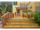 Elevated view of the backyard with a wooden deck, lush landscaping, and mature trees at 2227 Brevard Ne Rd, St Petersburg, FL 33704