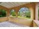 View from the balcony featuring archways looking out to the beautiful lush landscaping and surrounding neighborhood at 2227 Brevard Ne Rd, St Petersburg, FL 33704