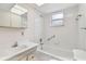 Clean bathroom featuring a white vanity, tub, and tiled shower surround at 2227 Brevard Ne Rd, St Petersburg, FL 33704