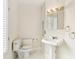 A charming bathroom featuring a pedestal sink, toilet, and a mirrored medicine cabinet at 2227 Brevard Ne Rd, St Petersburg, FL 33704