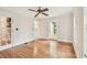 Sun-filled bedroom with hardwood floors, a ceiling fan, and a glass-paneled door at 2227 Brevard Ne Rd, St Petersburg, FL 33704