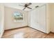 Bedroom with hardwood flooring, a ceiling fan, and a large closet at 2227 Brevard Ne Rd, St Petersburg, FL 33704
