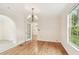Elegant dining room features wood floors and a chandelier at 2227 Brevard Ne Rd, St Petersburg, FL 33704