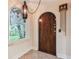 Inviting foyer with decorative light fixture and custom door at 2227 Brevard Ne Rd, St Petersburg, FL 33704