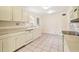 Bright kitchen with ample countertop space and white cabinetry at 2227 Brevard Ne Rd, St Petersburg, FL 33704