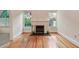 Inviting living room with a fireplace, hardwood floors, and natural light at 2227 Brevard Ne Rd, St Petersburg, FL 33704
