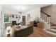 Bright living room with hardwood floors, fireplace, chandelier and neutral decor at 2227 Brevard Ne Rd, St Petersburg, FL 33704