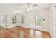 Living room with hardwood floors, a ceiling fan, and windows with shutters at 2227 Brevard Ne Rd, St Petersburg, FL 33704