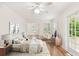 Serene main bedroom with hardwood floors, French doors and ensuite access at 2227 Brevard Ne Rd, St Petersburg, FL 33704