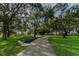 Serene park setting with winding path and mature trees, offering a peaceful outdoor retreat at 2227 Brevard Ne Rd, St Petersburg, FL 33704
