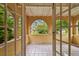 Covered patio with tile floor and arched opening to the yard at 2227 Brevard Ne Rd, St Petersburg, FL 33704