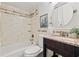 Updated bathroom with granite vanity, tiled walls, and bathtub with shower at 232 36Th N Ave # 202C, St Petersburg, FL 33704