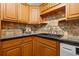 Kitchen featuring granite countertops, dark sink, and ample wood cabinetry at 232 36Th N Ave # 202C, St Petersburg, FL 33704