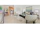 Inviting living room featuring tile flooring, modern decor, and an open layout to the dining area at 232 36Th N Ave # 202C, St Petersburg, FL 33704