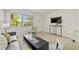 Cozy living room with a view, a mounted TV, and sleek furniture arrangement at 232 36Th N Ave # 202C, St Petersburg, FL 33704