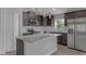 Modern kitchen with dark cabinetry, granite counters, stainless appliances, and wood-look flooring at 23440 Corinne Ave, Port Charlotte, FL 33980