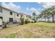 View of the backyard with a grassy area, palm trees, and view of the bay at 2700 Bayshore Blvd # 497, Dunedin, FL 34698