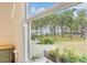 Balcony view with trees, water, lush greenery and outdoor seating at 2700 Bayshore Blvd # 497, Dunedin, FL 34698