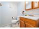 Cozy bathroom with oak cabinets, neutral tile, and single sink at 2700 Bayshore Blvd # 497, Dunedin, FL 34698