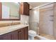 Bathroom with a granite countertop vanity and a glass enclosed tiled walk-in shower at 2700 Bayshore Blvd # 497, Dunedin, FL 34698