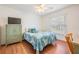 Cozy bedroom with a green armoire, wood-look floors, and a window overlooking the yard at 2700 Bayshore Blvd # 497, Dunedin, FL 34698