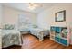 Bright bedroom featuring two twin beds, wood-look flooring, and a window with blinds at 2700 Bayshore Blvd # 497, Dunedin, FL 34698