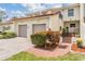Charming townhome exterior with two-car garage, red tile roof, and well-maintained landscaping at 2700 Bayshore Blvd # 497, Dunedin, FL 34698