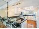 Modern kitchen with white cabinets, granite countertops, and a breakfast bar with seating at 2700 Bayshore Blvd # 497, Dunedin, FL 34698