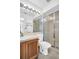 Updated bathroom featuring a walk-in shower, a white vanity, and a bright light fixture at 2749 Countryside Blvd # 20, Clearwater, FL 33761