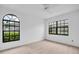 Sun-filled bedroom featuring windows with neighborhood views and neutral carpet at 2749 Countryside Blvd # 20, Clearwater, FL 33761