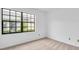 A light-filled bedroom features a large window with views of the front yard at 2749 Countryside Blvd # 20, Clearwater, FL 33761