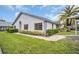 Charming single-story home featuring manicured landscaping and a mature palm tree at 2749 Countryside Blvd # 20, Clearwater, FL 33761