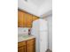 Functional kitchen featuring wooden cabinets and a full-size refrigerator at 2749 Countryside Blvd # 20, Clearwater, FL 33761
