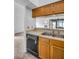 The kitchen features stainless steel appliances, wood cabinets, and a double sink at 2749 Countryside Blvd # 20, Clearwater, FL 33761
