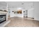 Open-concept living space with tile floors, fireplace, and views of the kitchen at 2749 Countryside Blvd # 20, Clearwater, FL 33761
