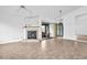 Bright living room with a fireplace, tile flooring, and sliding doors to a screened lanai at 2749 Countryside Blvd # 20, Clearwater, FL 33761