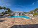 A pristine pool, surrounded by swaying palm trees and lounge chairs, offers a serene and inviting atmosphere at 2749 Countryside Blvd # 20, Clearwater, FL 33761