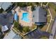 Aerial view of a community pool surrounded by lounge chairs and lush greenery, perfect for relaxation at 2749 Countryside Blvd # 20, Clearwater, FL 33761