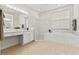 Bright bathroom featuring a tiled tub with shower, tiled floors, and vanity at 2901 Laurel Meadow Ct, Plant City, FL 33566