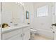 Clean bathroom featuring vanity, mirror with vanity lights, bathtub, toilet, and tiled floors at 2901 Laurel Meadow Ct, Plant City, FL 33566