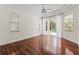Large bedroom with hardwood floors, access to a patio, and backyard pool views at 2901 Laurel Meadow Ct, Plant City, FL 33566