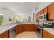 Well-lit kitchen with stainless appliances, countertop seating and view to open plan living at 2901 Laurel Meadow Ct, Plant City, FL 33566