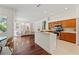 Open concept kitchen with breakfast bar, stainless steel appliances, and hardwood floors at 2901 Laurel Meadow Ct, Plant City, FL 33566